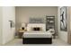 Inviting bedroom featuring a comfortable bed, decorative artwork, and natural light at 9565 Runaway Breeze Dr, Land O Lakes, FL 34637