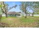 Overhead view of a large backyard with ample green space, a patio, a swing, and mature trees at 9712 White Barn Way, Riverview, FL 33569
