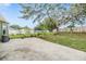 Spacious backyard with a concrete patio, lawn, and large trees, perfect for outdoor activities and relaxation at 9712 White Barn Way, Riverview, FL 33569