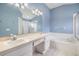 Bright bathroom with double sinks, a soaking tub, and a separate shower at 9712 White Barn Way, Riverview, FL 33569