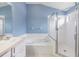 Bright bathroom with a soaking tub and a separate glass-enclosed shower at 9712 White Barn Way, Riverview, FL 33569