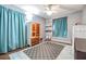 Nicely appointed bedroom with blue curtains, storage, and decor at 9712 White Barn Way, Riverview, FL 33569
