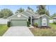 Charming single-story home showcasing a well-maintained lawn and attached two-car garage at 9712 White Barn Way, Riverview, FL 33569