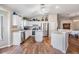 Bright kitchen featuring white cabinets, stainless steel appliances, and wood-look floors at 9712 White Barn Way, Riverview, FL 33569