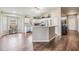 Large kitchen with white cabinets, stainless appliances, and spacious wood-look flooring at 9712 White Barn Way, Riverview, FL 33569