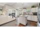 Bright kitchen with a view into the office area, complete with stainless appliances and white cabinets at 9712 White Barn Way, Riverview, FL 33569