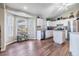 Open kitchen with stainless appliances, white cabinets, and bay window at 9712 White Barn Way, Riverview, FL 33569