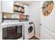 Well-organized laundry room with washer, dryer, shelving, and a decorative welcome sign at 9712 White Barn Way, Riverview, FL 33569