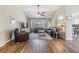 Open living room with hardwood floors, ceiling fan, and lots of natural light at 9712 White Barn Way, Riverview, FL 33569