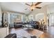 Bright living room with hardwood floors, comfortable seating and ceiling fan at 9712 White Barn Way, Riverview, FL 33569