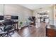Open floor plan of an office, with a glimpse into the kitchen, connected by an archway at 9712 White Barn Way, Riverview, FL 33569