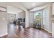 Bright living room with wood floors and bay window letting in natural light at 9712 White Barn Way, Riverview, FL 33569