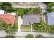 Aerial view of a well-maintained home with a long driveway and lush landscaping at 9908 Alafia River Ln, Gibsonton, FL 33534