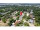 An aerial perspective showcases a residential area with a highlighted home, identified by a red arrow at 9908 Alafia River Ln, Gibsonton, FL 33534