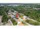 Aerial view of a charming home in a serene, tree-lined neighborhood, highlighted with a red arrow at 9908 Alafia River Ln, Gibsonton, FL 33534