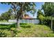 The large, shady backyard features a privacy fence and is perfect for Gathering fun at 9908 Alafia River Ln, Gibsonton, FL 33534