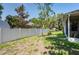 This backyard is fully fenced for privacy, and has mature trees that provide shade at 9908 Alafia River Ln, Gibsonton, FL 33534