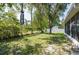 This backyard features a fenced perimeter and mature trees at 9908 Alafia River Ln, Gibsonton, FL 33534