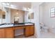 Bathroom with dual sinks, vanity, and a separate toilet room at 9908 Alafia River Ln, Gibsonton, FL 33534