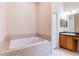 Bathroom showcasing a soaking tub, vanity, and tile accents at 9908 Alafia River Ln, Gibsonton, FL 33534