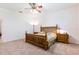 Bedroom featuring neutral walls, ceiling fan, and wooden bedframe at 9908 Alafia River Ln, Gibsonton, FL 33534