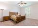 Bedroom with hardwood furnishings, plush carpet, and plantation shutters at 9908 Alafia River Ln, Gibsonton, FL 33534