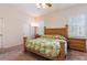 Bedroom with wooden furniture, ceiling fan, and a window with shutters at 9908 Alafia River Ln, Gibsonton, FL 33534