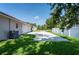 Long driveway leading to a two-car garage next to green grass and a white fence at 9908 Alafia River Ln, Gibsonton, FL 33534