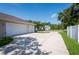 Long driveway leading to a three-car garage with room for parking in front of the house at 9908 Alafia River Ln, Gibsonton, FL 33534