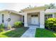 Welcoming front entry with an inviting walkway leading to the double doors and covered porch at 9908 Alafia River Ln, Gibsonton, FL 33534