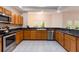 Fully equipped kitchen with stainless steel appliances, lots of cabinets, and an opening to the living area at 9908 Alafia River Ln, Gibsonton, FL 33534
