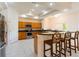 Bright kitchen featuring stainless steel appliances, granite countertops, and breakfast bar at 9908 Alafia River Ln, Gibsonton, FL 33534