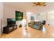 Bright living room with hardwood floors, a ceiling fan, and comfortable seating at 9908 Alafia River Ln, Gibsonton, FL 33534