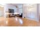 Bright living room boasts beautiful bamboo floors, natural light, and a ceiling fan for added comfort at 9908 Alafia River Ln, Gibsonton, FL 33534