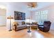 Inviting living room features a comfortable seating arrangement, complemented by natural light and a ceiling fan at 9908 Alafia River Ln, Gibsonton, FL 33534