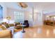 Spacious living room with bamboo flooring, ceiling fan, and an adjacent dining area perfect for entertaining at 9908 Alafia River Ln, Gibsonton, FL 33534