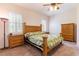 Cozy bedroom with ample natural light, carpet, and wooden furniture at 9908 Alafia River Ln, Gibsonton, FL 33534