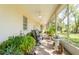 This screened-in patio has ample seating and lush greenery for relaxation at 9908 Alafia River Ln, Gibsonton, FL 33534