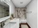 Modern bathroom with a stylish vanity, a soaking tub with a shower, and a trendy tile backsplash at 10011 46Th W Ave, Bradenton, FL 34210