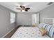 Bright bedroom featuring a ceiling fan, natural light, and a comfortable bed with decorative pillows at 10011 46Th W Ave, Bradenton, FL 34210