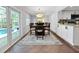 Bright dining room with a modern light fixture, a dining table with chairs, and pool views at 10011 46Th W Ave, Bradenton, FL 34210