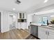 Open kitchen with white cabinets, modern appliances, and a view of the backyard and pool area at 10011 46Th W Ave, Bradenton, FL 34210