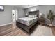 Serene main bedroom with wood floors, neutral colors, and a large bed with stylish bedside tables at 10011 46Th W Ave, Bradenton, FL 34210