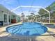 Backyard pool area with blue water, screened enclosure, and lounge chairs, perfect for relaxation at 10011 46Th W Ave, Bradenton, FL 34210