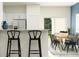 Open kitchen with breakfast bar, stainless steel appliances, and dining area access at 10193 Trumpet Honeysuckle Way, San Antonio, FL 33576