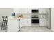 Modern kitchen with white cabinets, stainless steel appliances, and granite countertops at 10193 Trumpet Honeysuckle Way, San Antonio, FL 33576