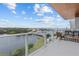 Large, covered balcony with glass railings and panoramic waterfront views at 1020 Sunset Point Rd # 712, Clearwater, FL 33755