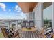 Open balcony with furniture and stunning views of the bay at 1020 Sunset Point Rd # 712, Clearwater, FL 33755