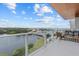 Enjoy a breathtaking waterfront view from this luxury balcony with comfortable seating and privacy glass railing at 1020 Sunset Point Rd # 712, Clearwater, FL 33755