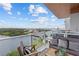 Condo balcony offers panoramic water views, seating, and stylish decor for relaxing outdoor enjoyment at 1020 Sunset Point Rd # 712, Clearwater, FL 33755